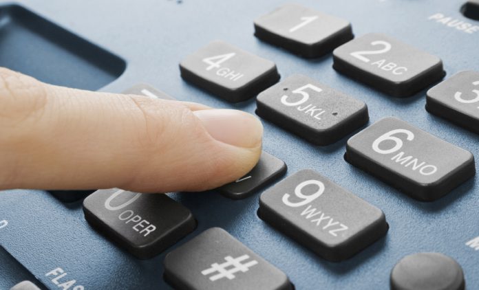 office black telephone with hand isolated on white